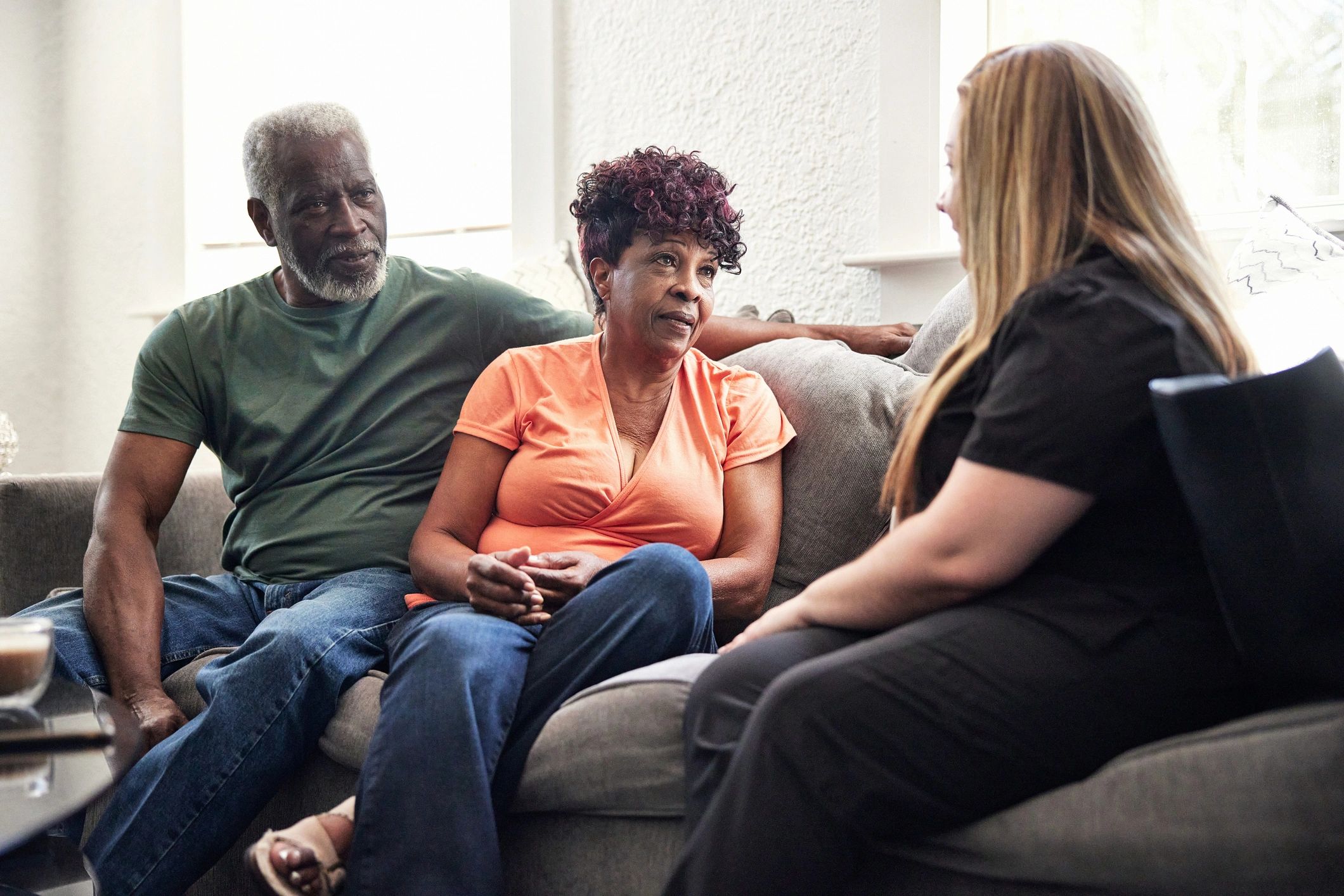 Worker speaking with clients in a home setting