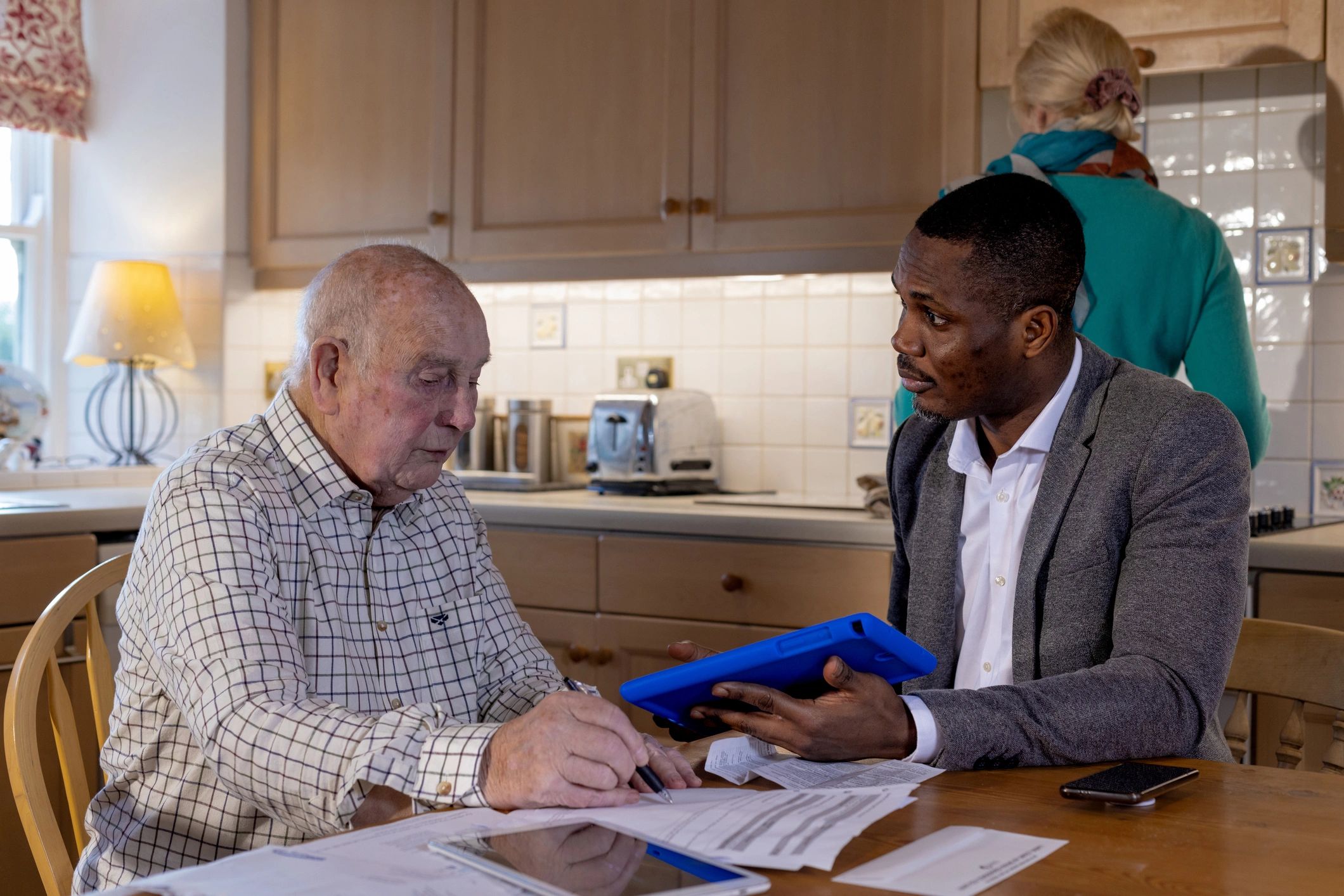 Support worker meeting with a family at a table