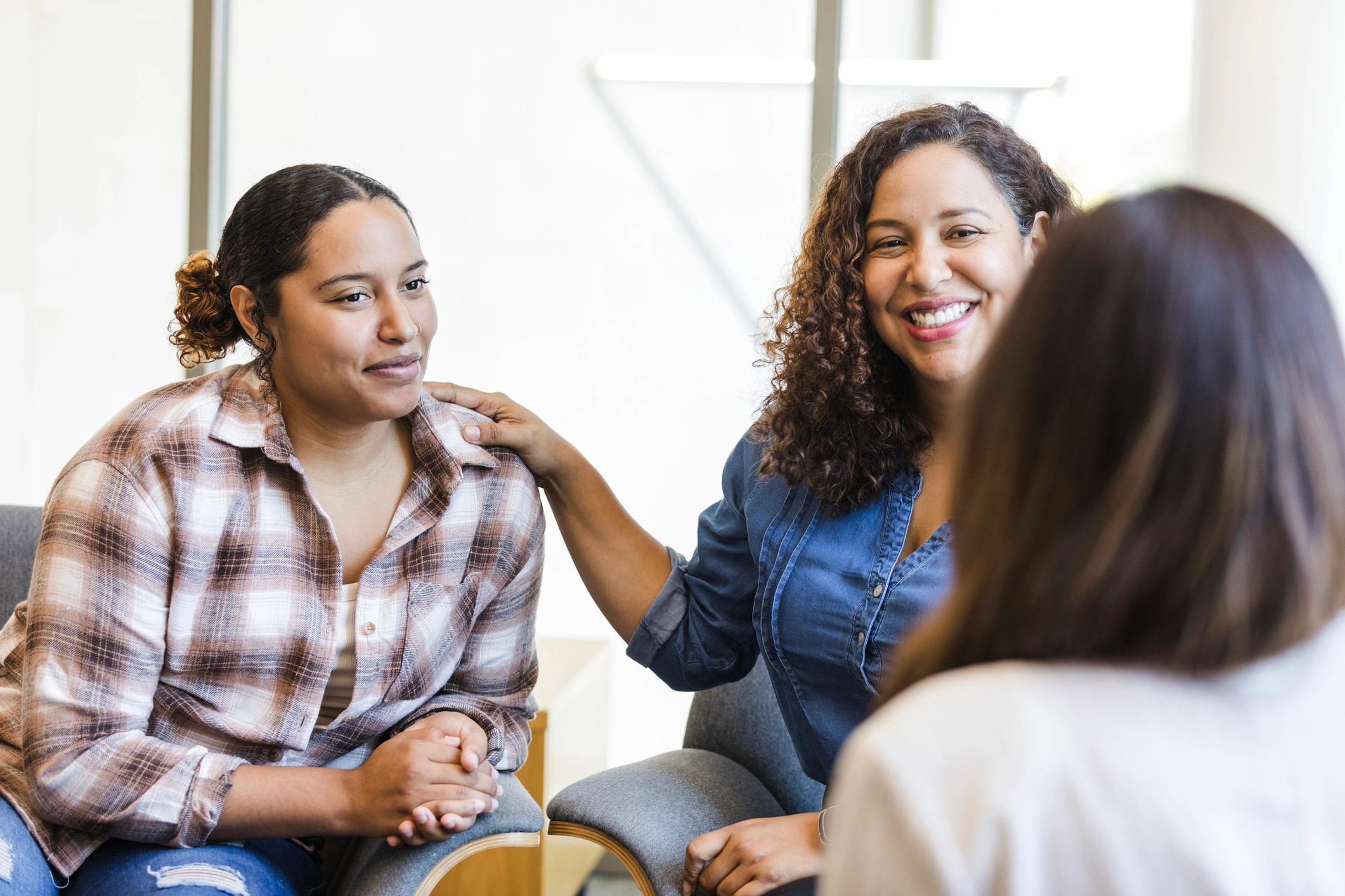 Facilitated family meeting with a parent and young person speaking with a support professional